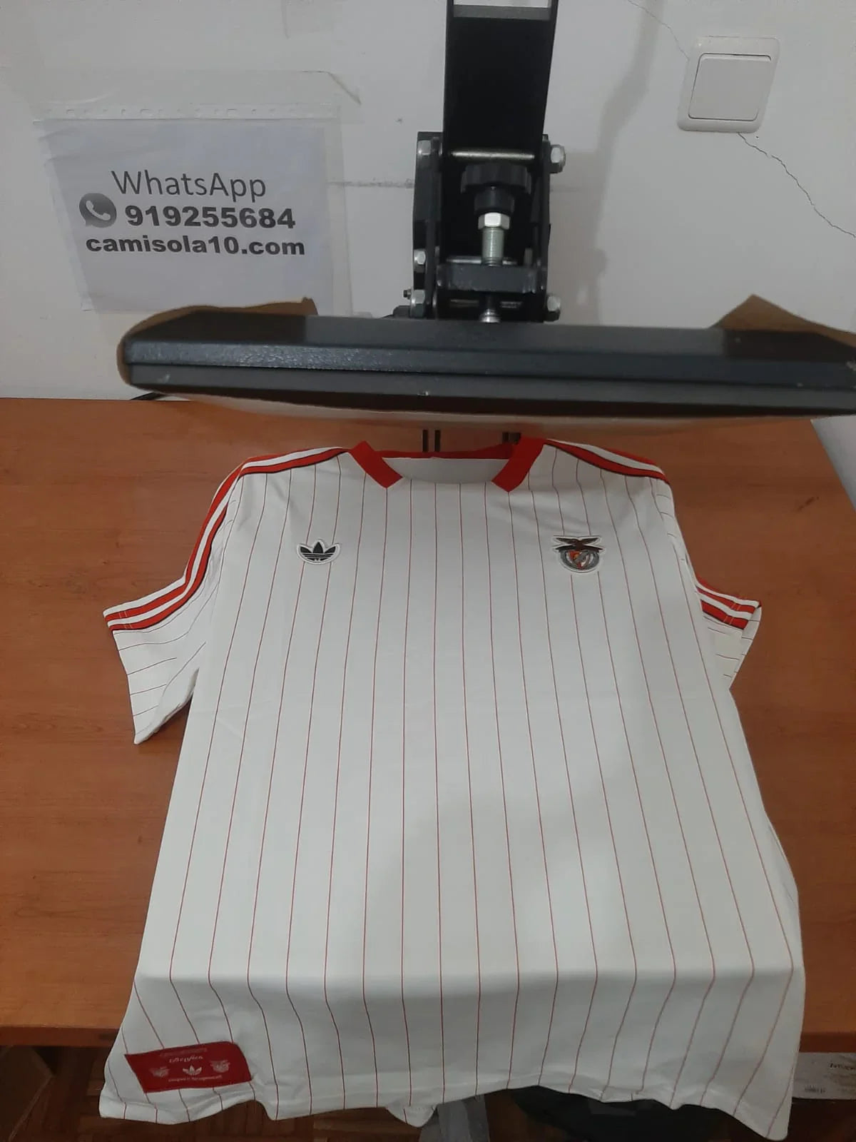 Vista frontal da Camisola Retro Branca do SL Benfica 25/26 Edição Especial na prensa de estampagem