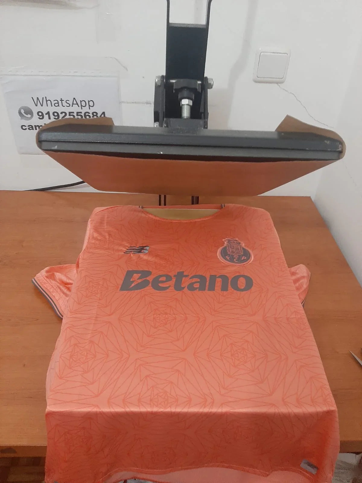 Vista frontal da camisola alternativa rosa do FC Porto 25/26 na prensa de estampagem - Camisola 10.